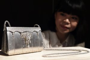 A Ginza Tanaka employee shows off 200-million-yen (1,626,016 USD) diamond bijou bag made of 208ct, 2182-diamonds and platinum during a platinum exhibition press preview in Tokyo on June 18, 2015. Japan's jewelry company, Ginza Tanaka will hold the exhibition, 