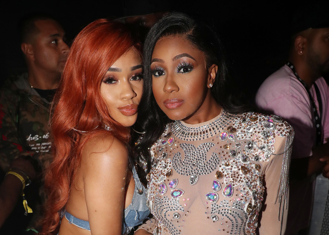 Saweetie and Yung Miami pose for photos backstage.