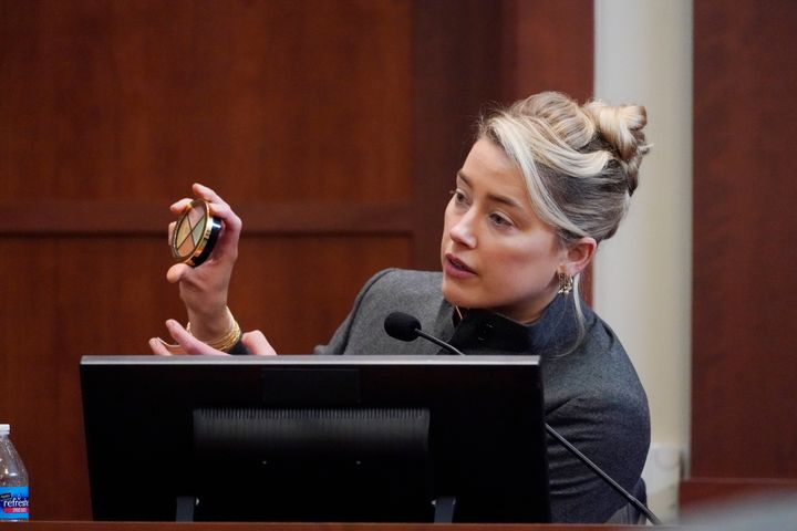 Actor Amber Heard displays a makeup kit during her testimony at the Fairfax County Circuit Courthouse in Virginia on May 16, 2022. 