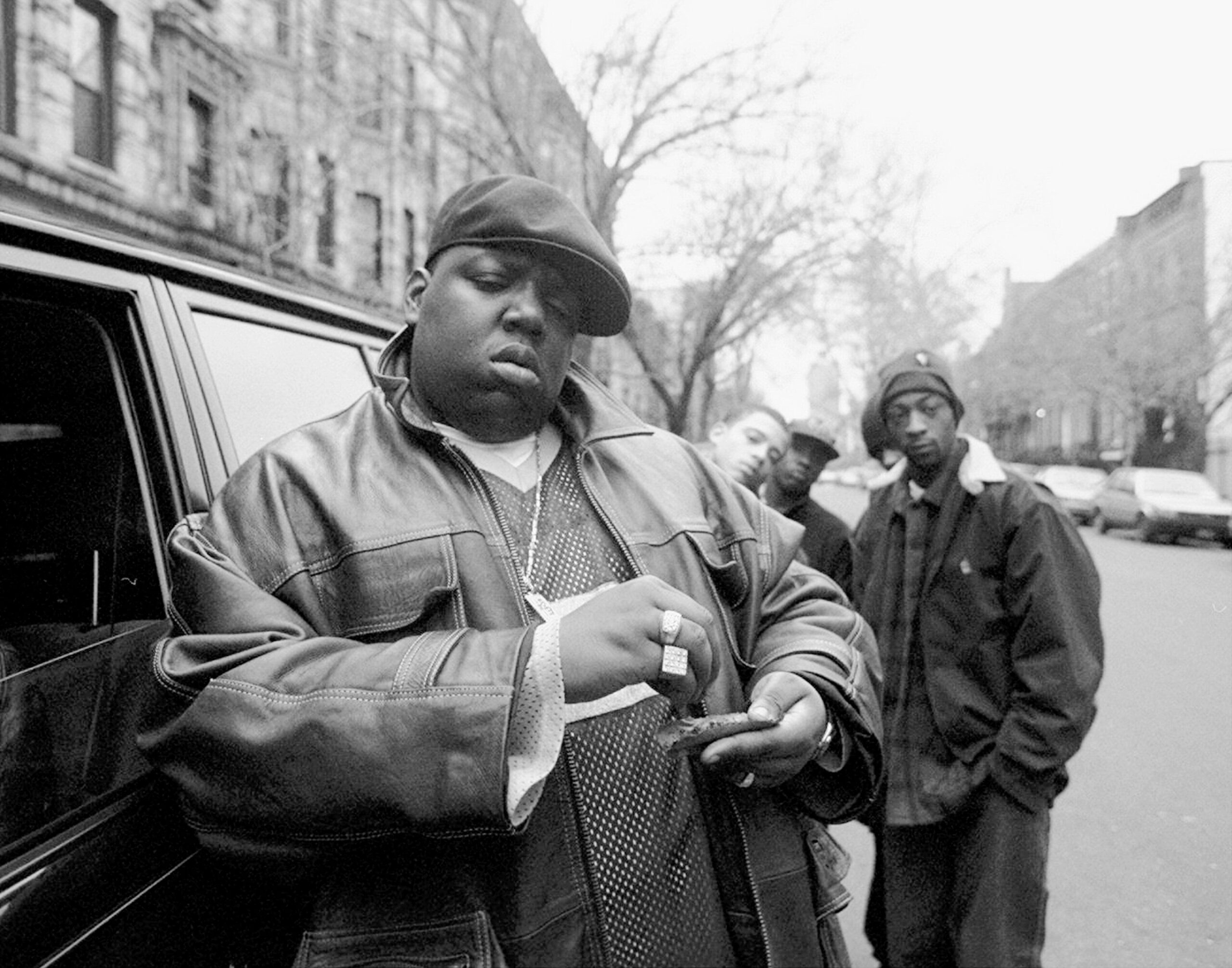 American rapper Notorious B.I.G., also known as Biggie Smalls, whose legal name was Chris Wallace (1972 - 1997), rolls a cigar-looking item outside his mother's house in Brooklyn, New York, Jan. 18, 1995. 