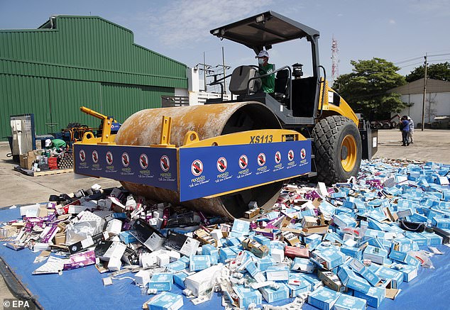 A steamroller crushes counterfeit and license violating goods during a destruction ceremony of intellectual property rights infringing goods in Bangkok, Thailand, on August 31, 2023