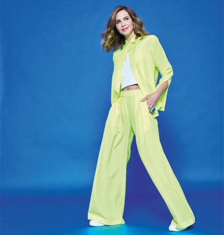 Trinny Woodall in green suit, against blue background