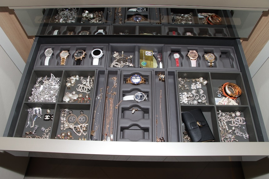 Valuable collectables in a drawer including watches and jewellery in a drawer.