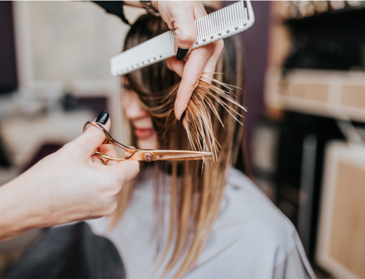 Woman at a salon getting a trim