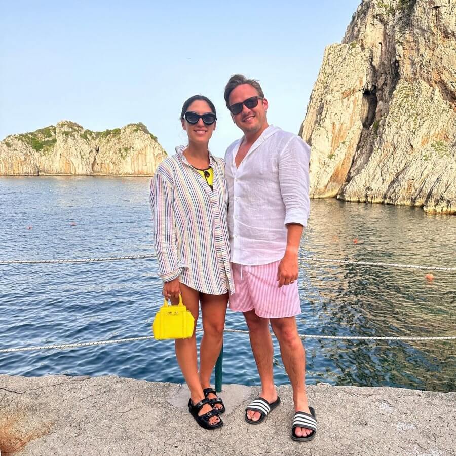 Ellie and her husband Dario pose by the water in Italy