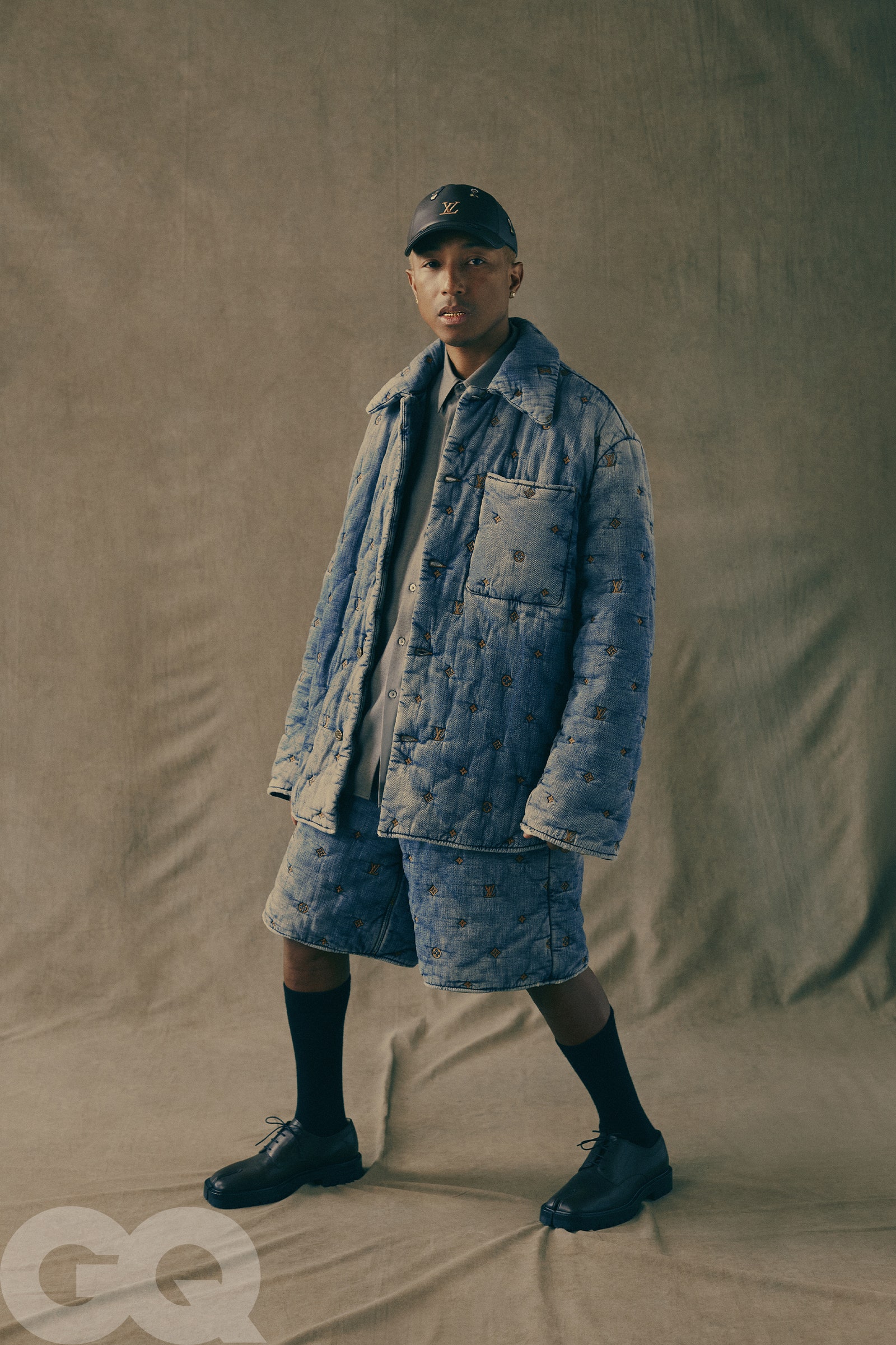 Jacket shorts and hat by Louis Vuitton Mens. Shirt by Auralee. Shoes by Maison Margiela. Socks by Falke.