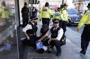 Police officers detain a man near Oxford Street in central London, after viral TikTok videos urged youngsters to rob the JD Sports store on Oxford Street.