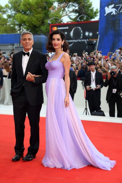 clooney wearing a pale purple flowing dress