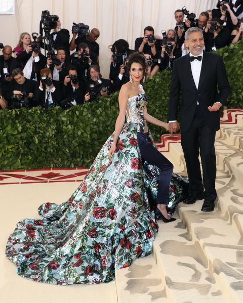 clooney wearing a floral train dress with pants and metallic bodice