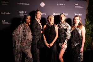 Lillardia Briggs-Houston (centre), winner of the Fashion Designer Award at the 2023 National Indigenous Fashion Awards, flanked by models wearing her designs. 