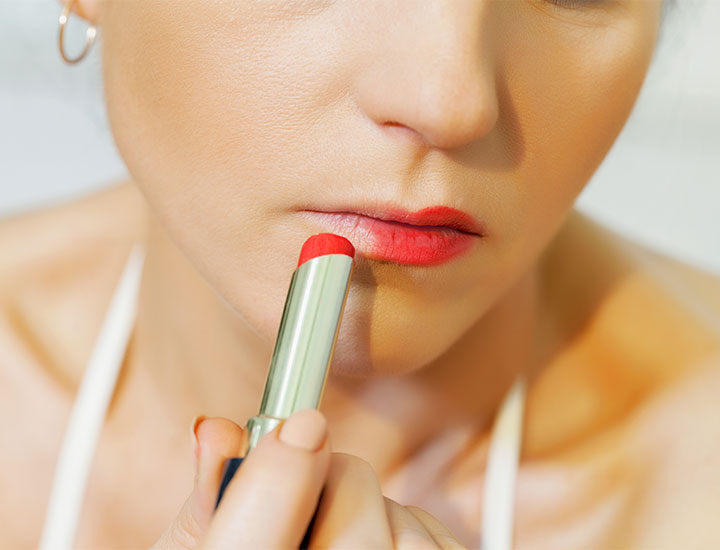 anonymous-woman-applies-lipstick