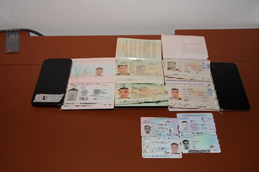 Passports with details blurred out sitting on a table