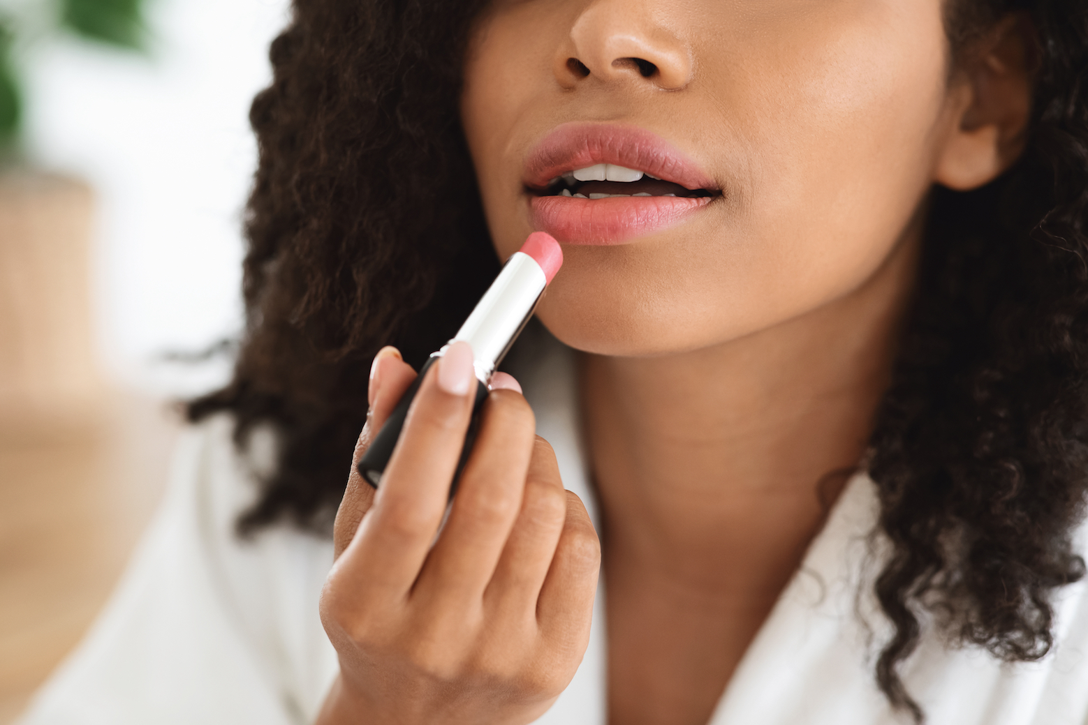 woman applying lipstick