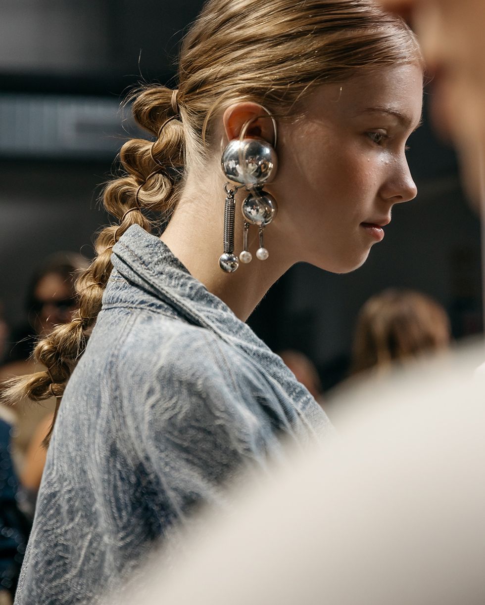 a model wears silver earrings on the gestuz runway at copenhagen spring 2024 fashion trends