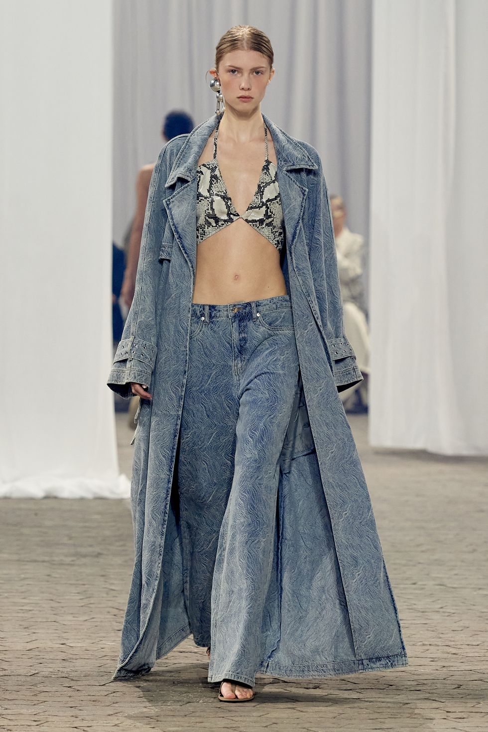 a model at gestuz wears printed denim in a guide to spring 2024 fashion trends