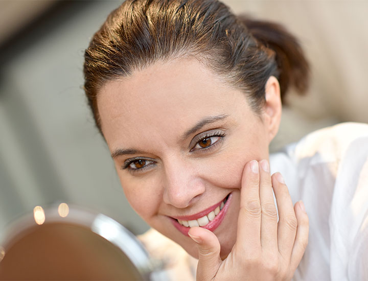 woman-smiles-at-reflection