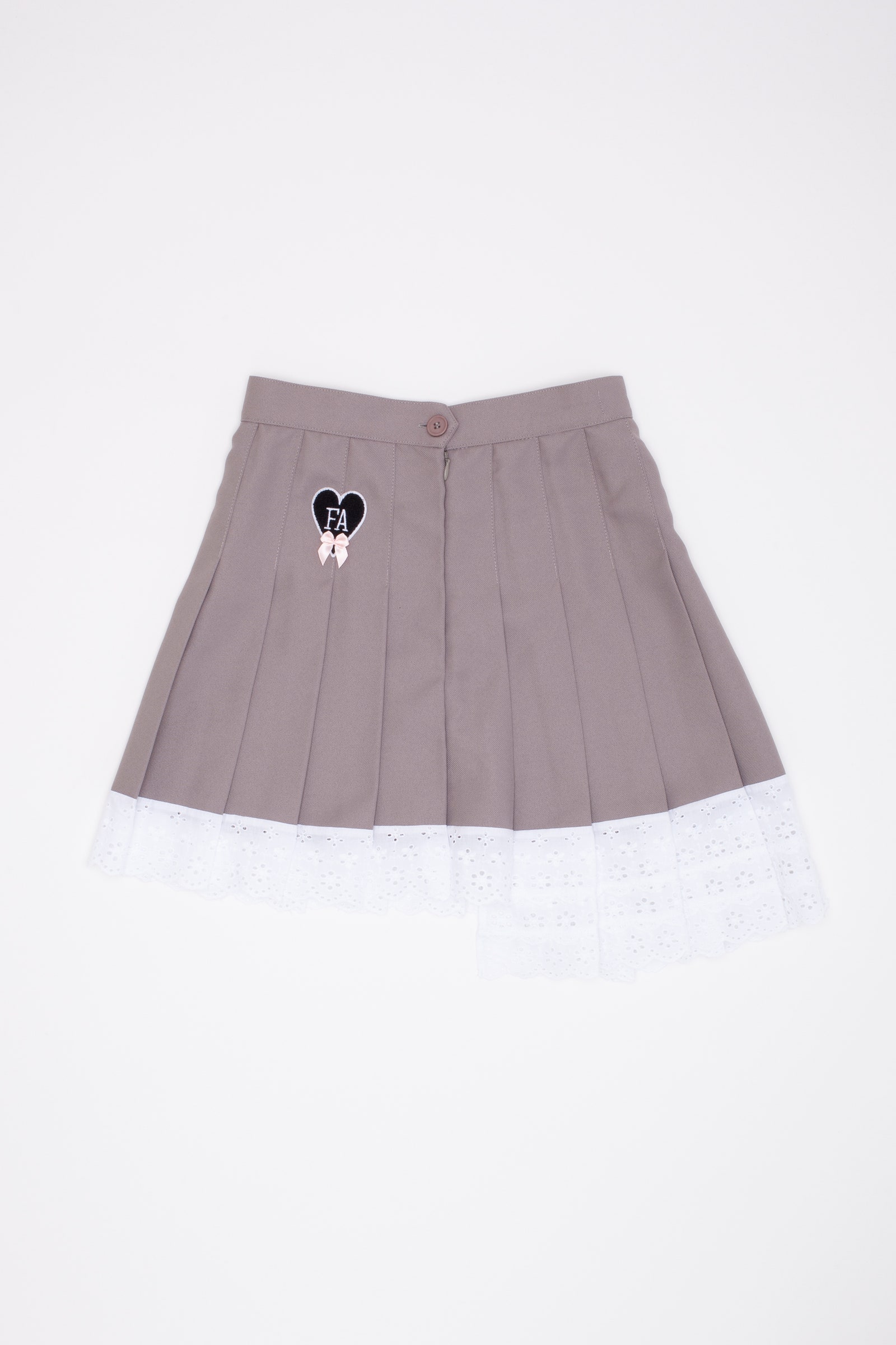 A gray tennis skirt with a black heart patch and lace trim.