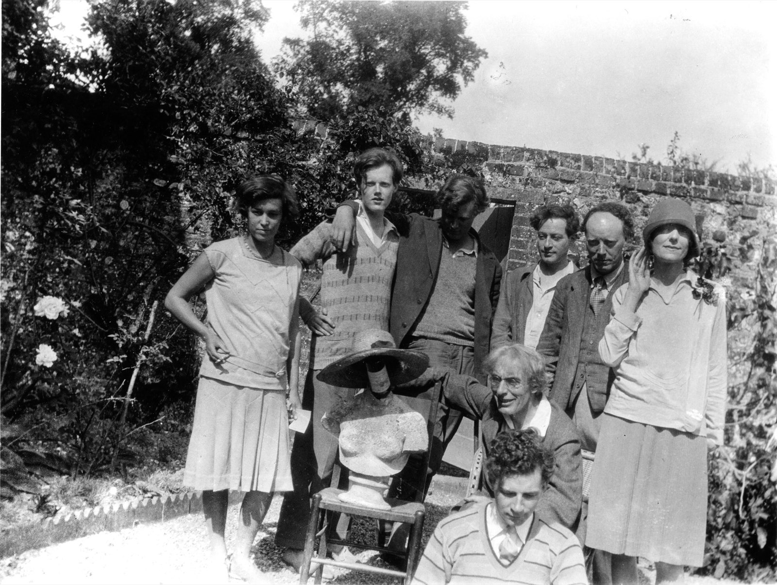 A group of writers and artists in the walled garden at Charleston.