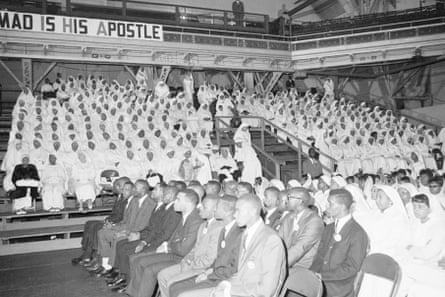 A group of Black Muslims at a convention seated, with the women wearing all white