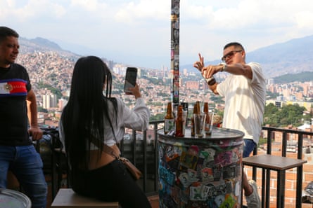 Tourists take photos at a brewery run by a former gang member