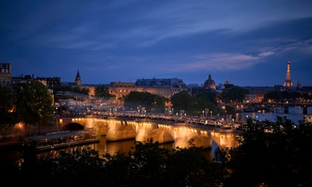 Models parade down Pont Neuf Bridge during the Louis Vuitton Menswear Spring/Summer 2024 show.