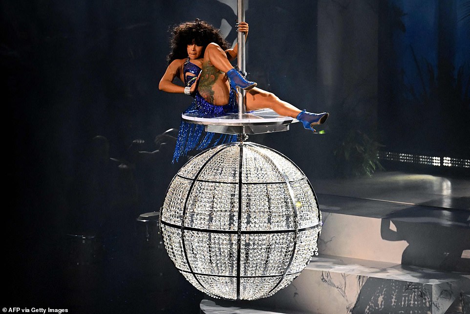 Making her entrance! It all began with Cardi, 30, descending on a chandelier before she kicked off the track on her own