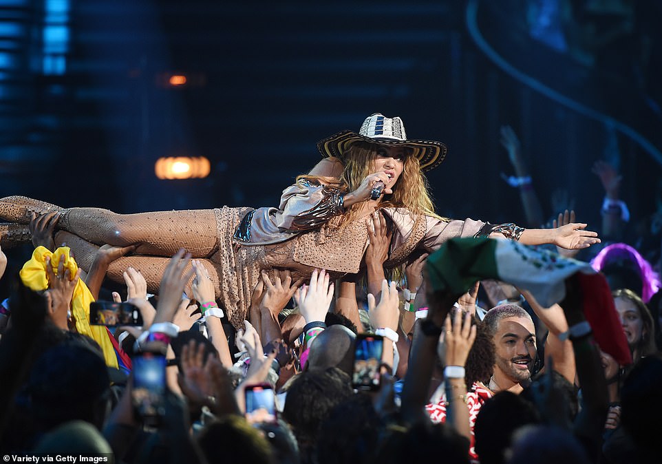 Rock star! She went crowd surfing with the assistance of her backup dancers