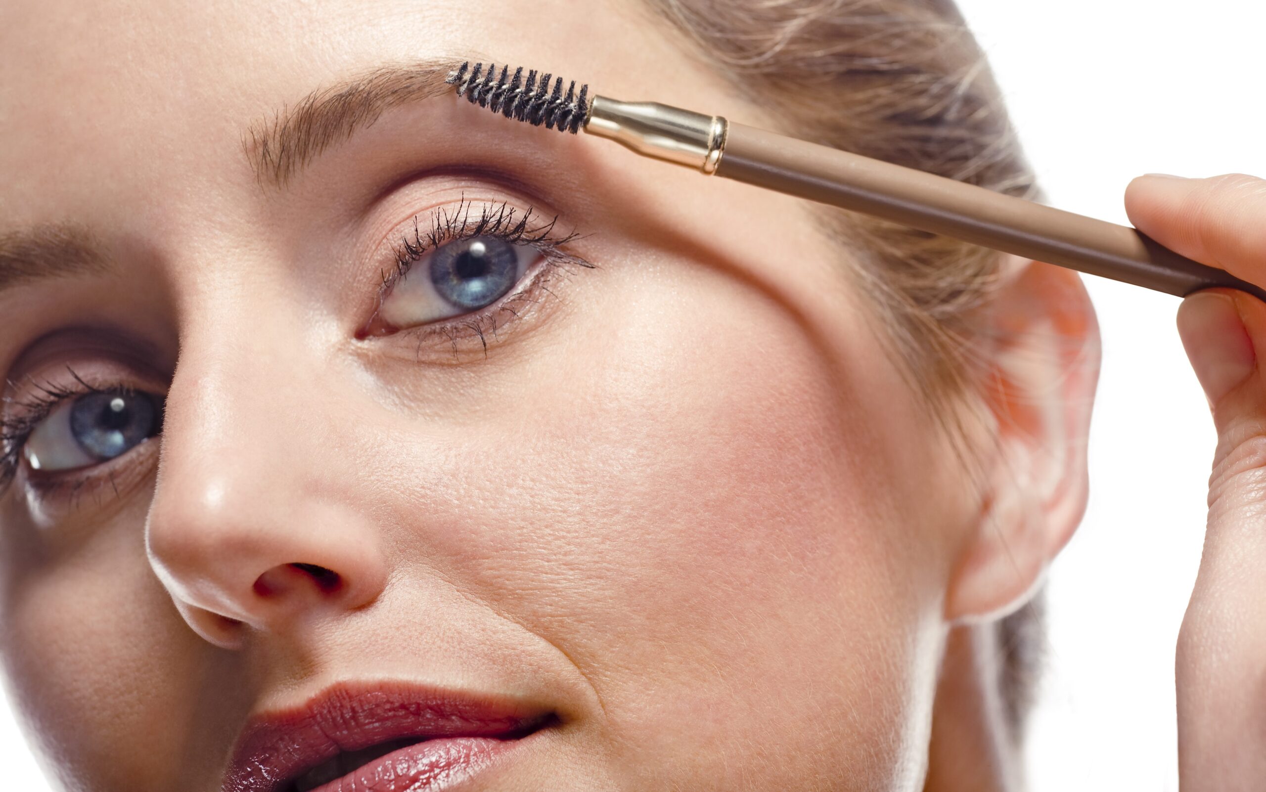 Woman using a soap brow technique to fill in sparse eyebrows