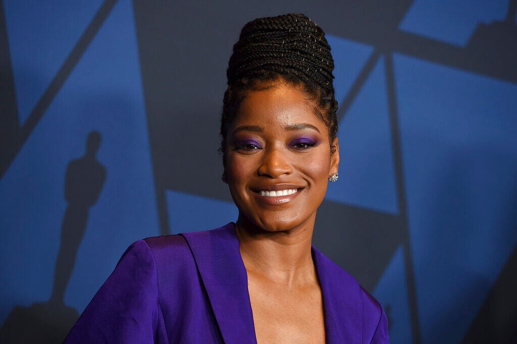 Keke Palmer smiles, posing for a photo.