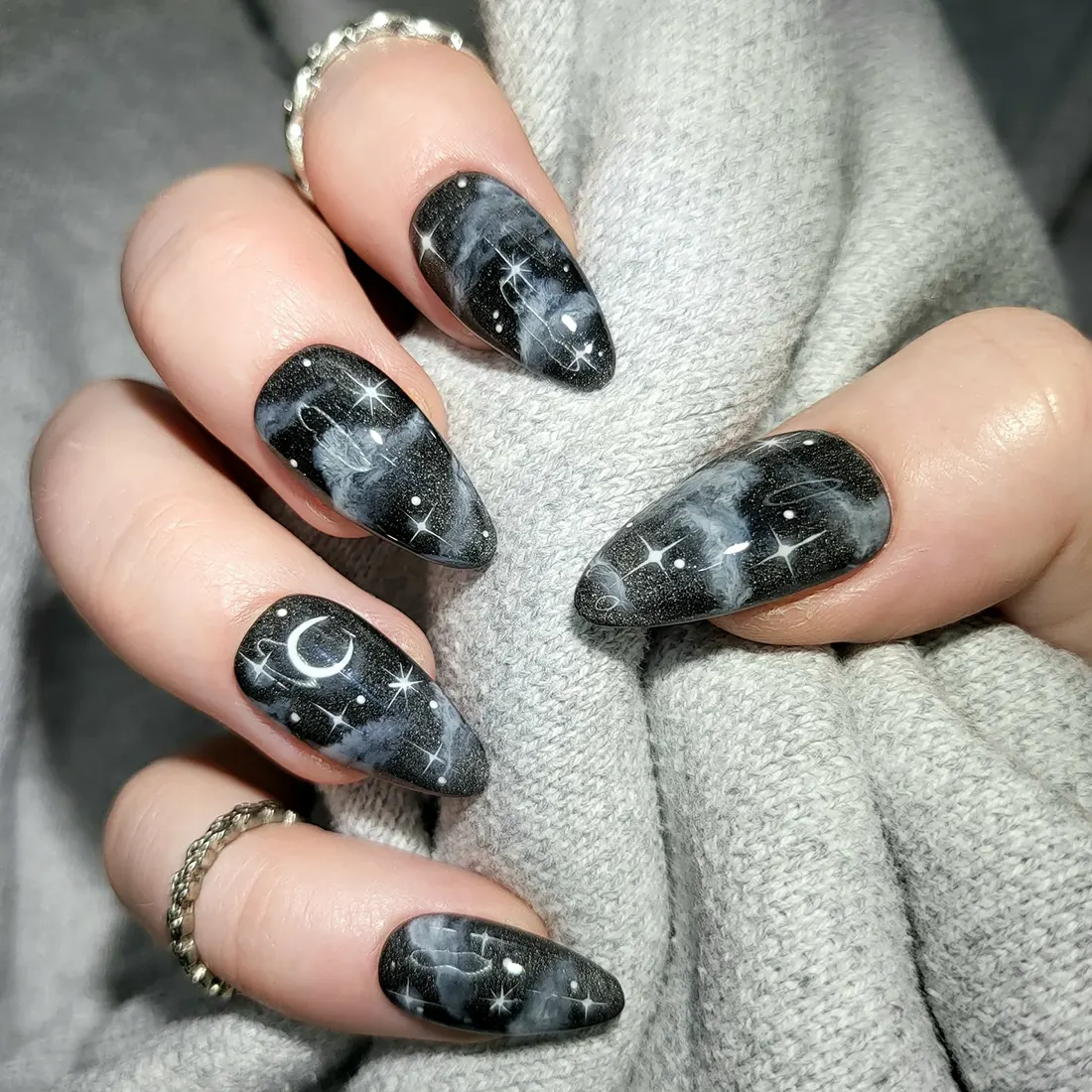 Close up of nails featuring a cloudy night sky design | 9 Witchy Nail Designs You Can Buy as Press-Ons on Etsy | Slashed Beauty