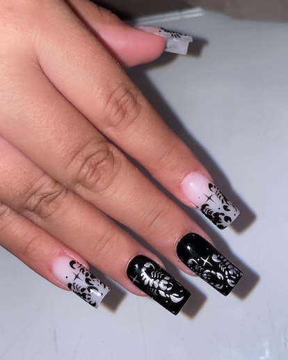 A black & white scorpion nail design to provide inspiration for scorpio season 2023 nail art ideas.