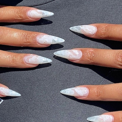 If you need ideas for vampire nails for Halloween 2023, try a white marble nail design on stiletto-s...