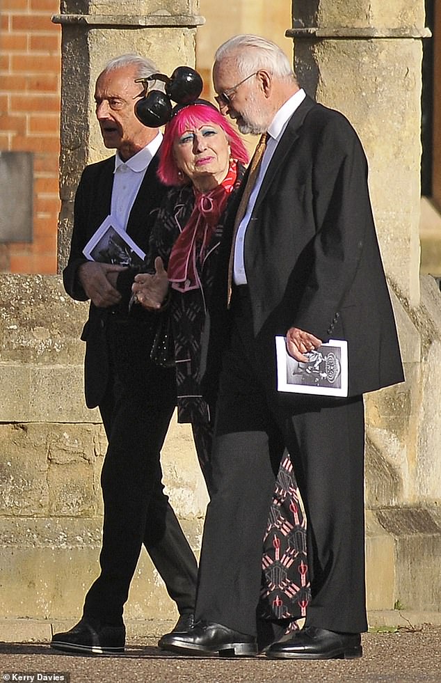 Some guests reflected Dame Mary's love of colour and fun as they wore bright clothing, with one pink-haired woman donning a black cherry headband (pictured)