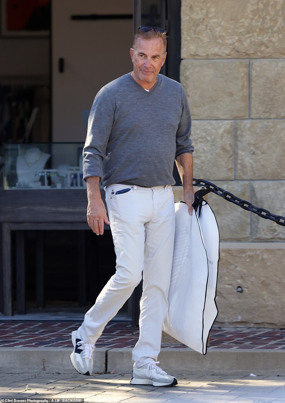 Still dashing at 68: . The Yellowstone actor looked tanned and slender in his casual attire which consisted of gray V-neck sweater, white pocketed denim jeans and white-and-gray sneakers