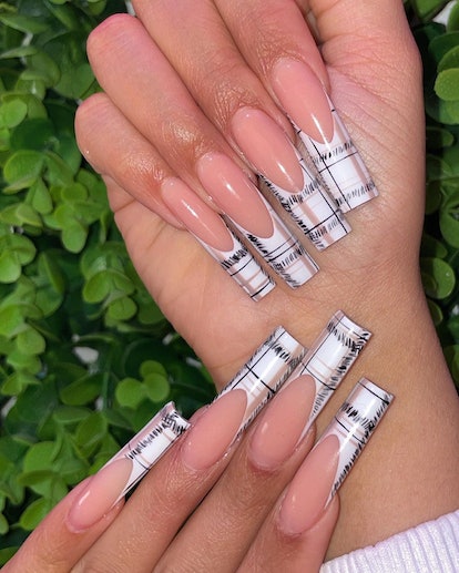 A long, square-shaped manicure with plaid French tips.