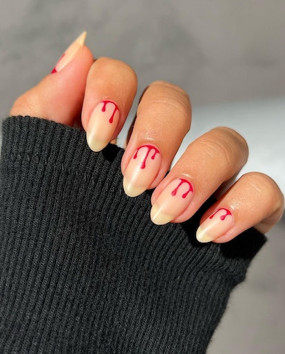 A blood drip nail art design that's inspired by 