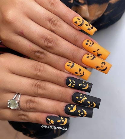 Orange & black jack o' lanterns are a cute pumpkin nail art design idea for fall 2023.