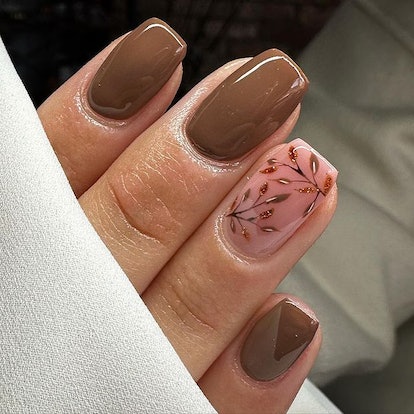 Brown nails with leaf design.