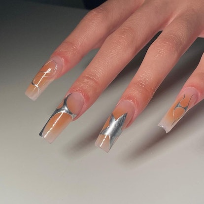 Orange aura nails with chrome details are a cute pumpkin-inspired nail art design idea for fall 2023...