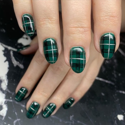 Short, dark green plaid nails.