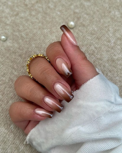 Brown chrome nails.