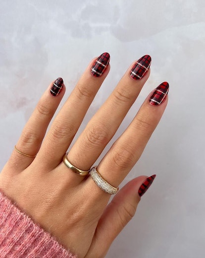 Red plaid nails with a silver chrome accent.