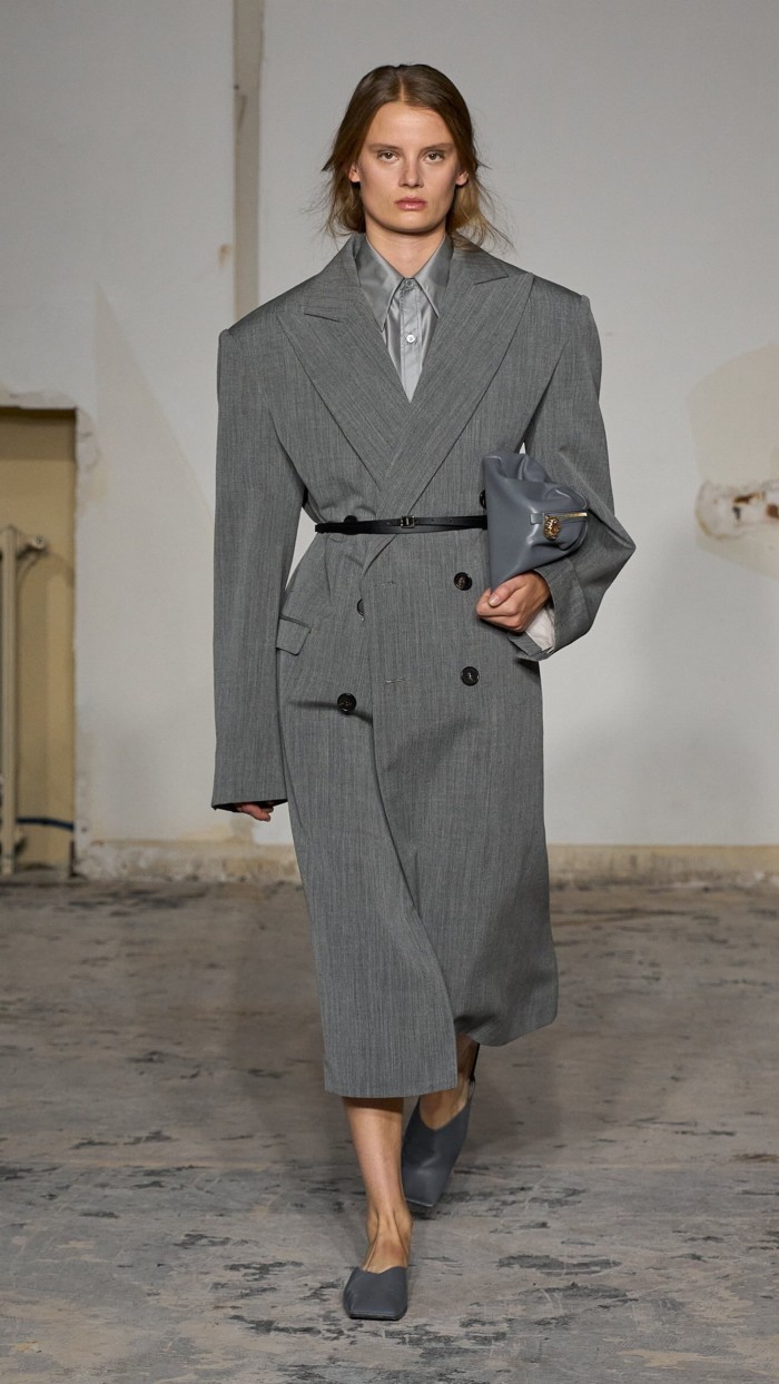 A model is a square shouldered belted grey coat