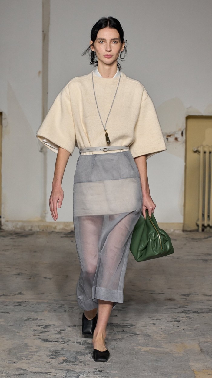 A model in a loose-cut top over a gauzy skirt