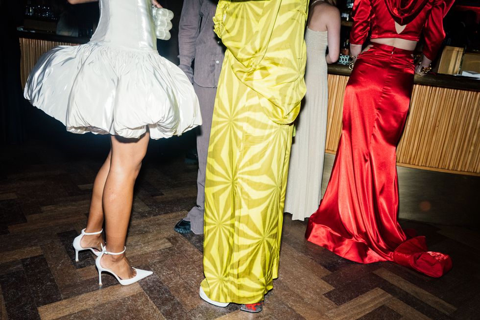 a group of people wearing dresses