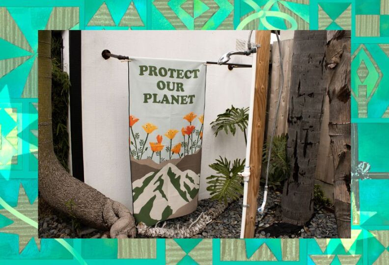 A generously-sized beach towel that reads, Protect Our Planet, and features images of California poppies growing up from the dirt. The image is set against a decorative green background accented with stars, gift boxes and strands of ribbon.