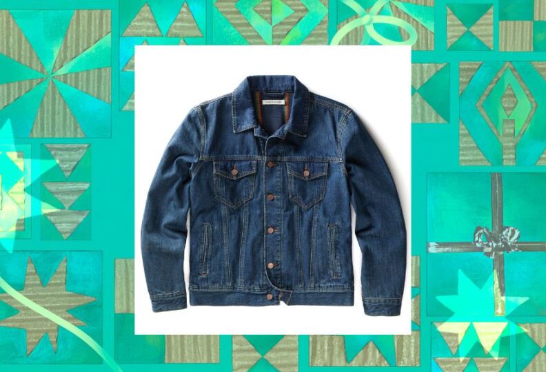 A jacket that looks like a traditional jean jacket, but upon closer inspection it's anything but typical. The lining is made out of a blanket, for an extra cozy feel. The image is set against a decorative green background accented with stars, gift boxes and strands of ribbon.