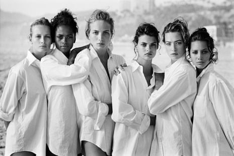 Models Estelle Lefébure, Karen Alexander, Rachel Williams, Linda Evangelista, Tatjiana Patitz and Christy Turlington, earing white shirts, on a beach in Malibu, 1988