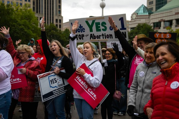 People attend a rally hosted by Ohioans United for Reproductive Rights outside of the Ohio Statehouse.