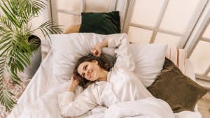 Young beautiful, woman waking up fully rested.